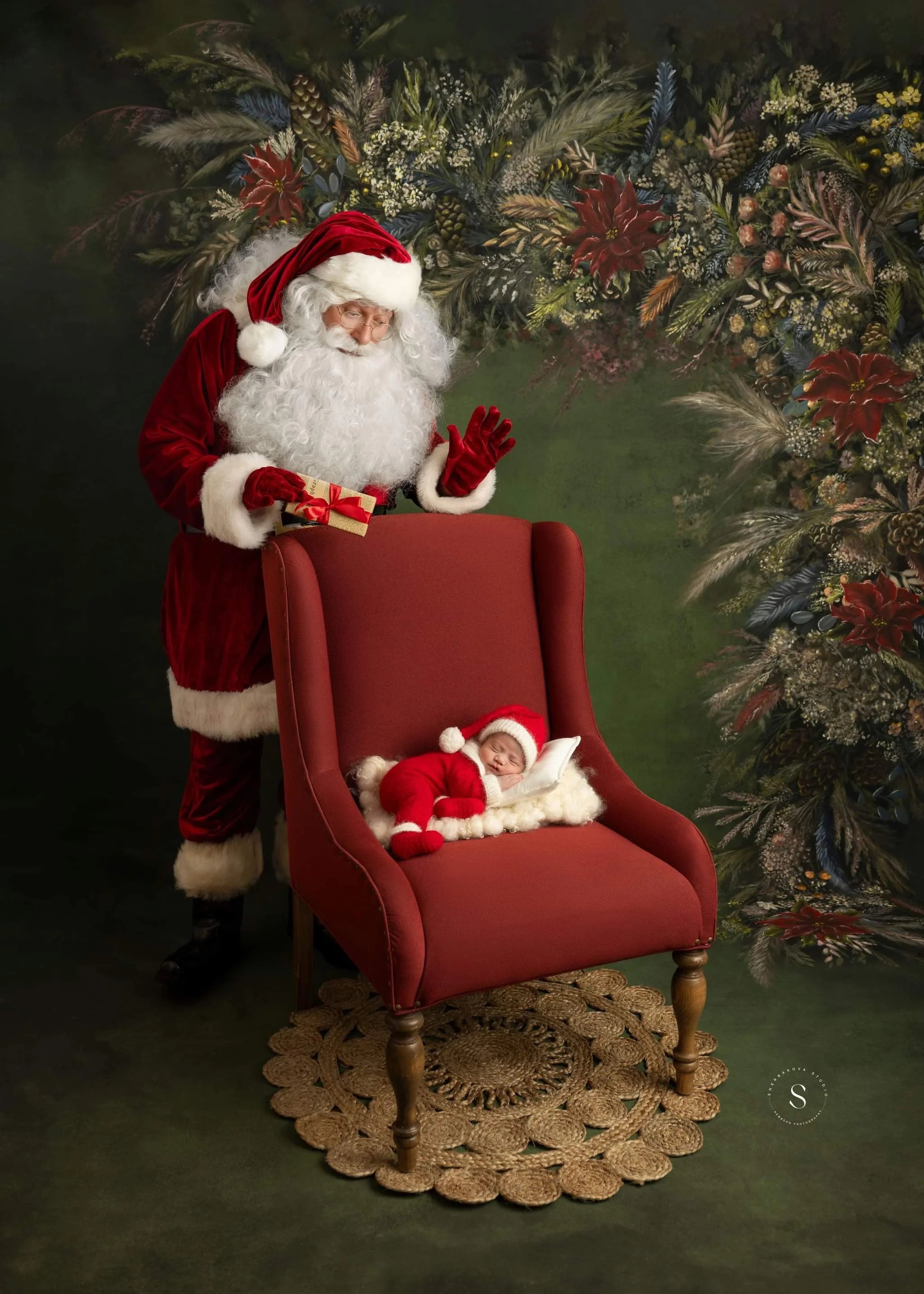 Santa Claus with a baby in a red chair against a festive background