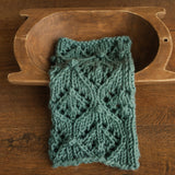 Soft hand-knitted newborn layer with tiny pom-poms — delicate wool prop ideal for baskets, wraps, or layered newborn photography setups.