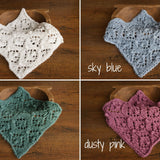 Soft hand-knitted newborn layer with tiny pom-poms — delicate wool prop ideal for baskets, wraps, or layered newborn photography setups.