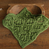 Soft hand-knitted newborn layer with tiny pom-poms — delicate wool prop ideal for baskets, wraps, or layered newborn photography setups.