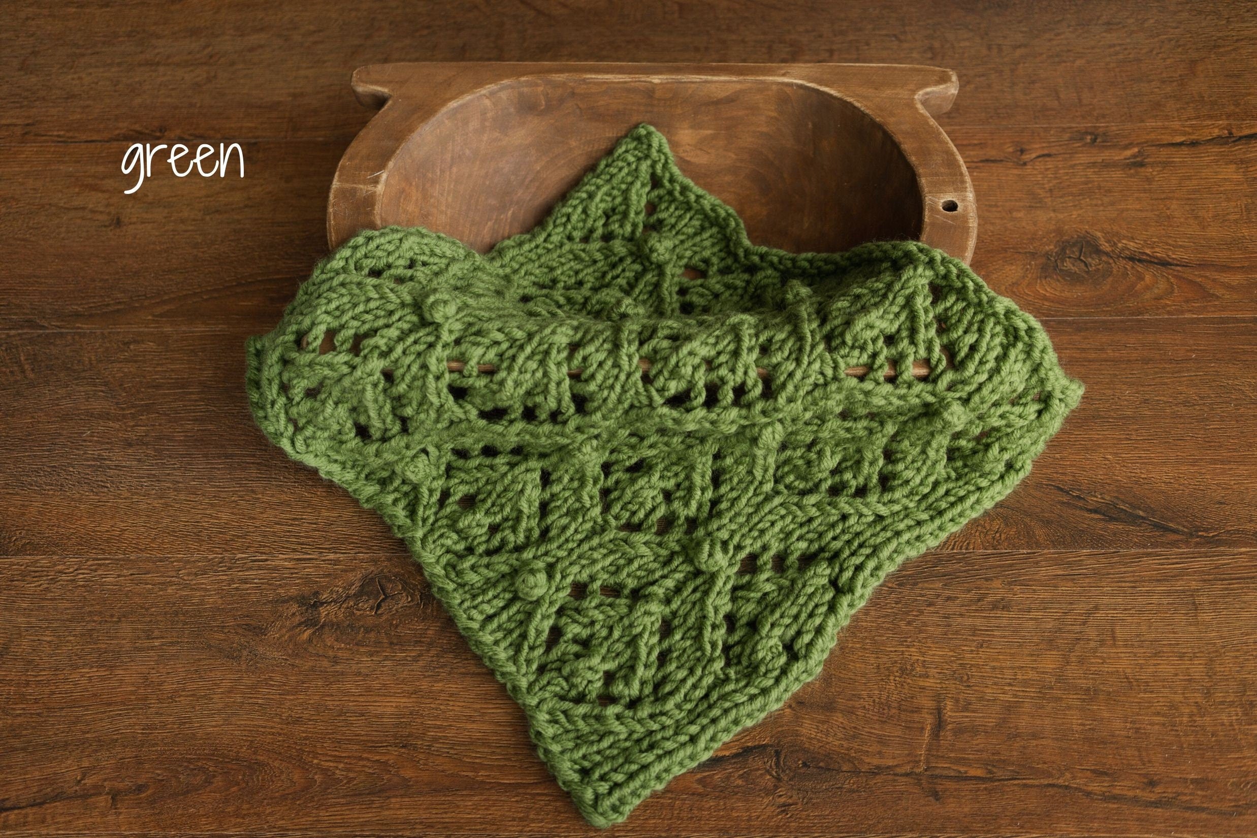 Soft hand-knitted newborn layer with tiny pom-poms — delicate wool prop ideal for baskets, wraps, or layered newborn photography setups.