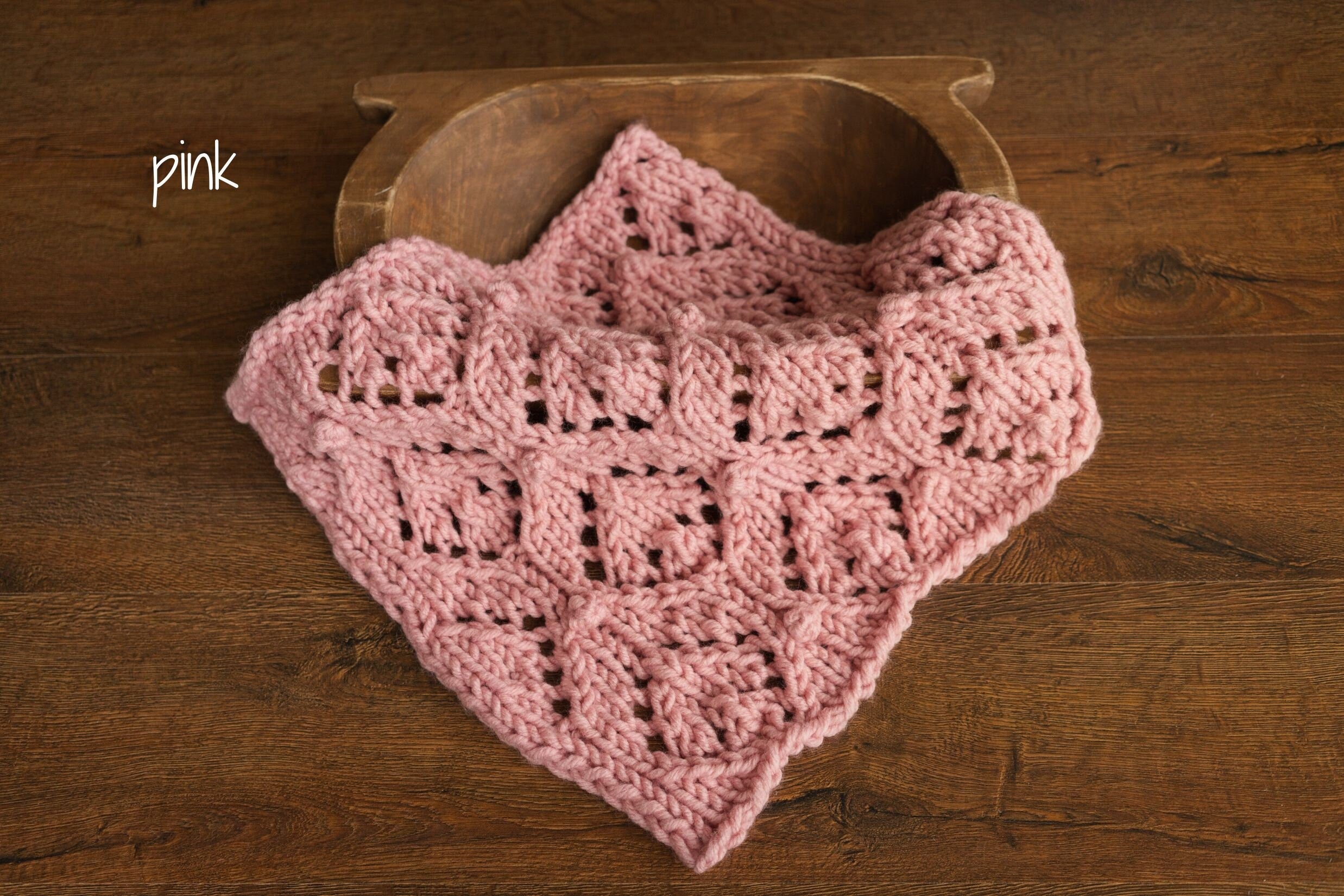 Soft hand-knitted newborn layer with tiny pom-poms — delicate wool prop ideal for baskets, wraps, or layered newborn photography setups.