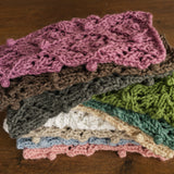 Soft hand-knitted newborn layer with tiny pom-poms — delicate wool prop ideal for baskets, wraps, or layered newborn photography setups.